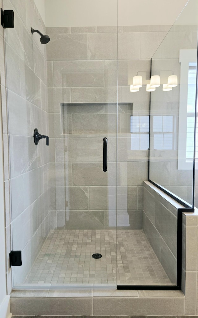 bathroom featuring a shower with shower door