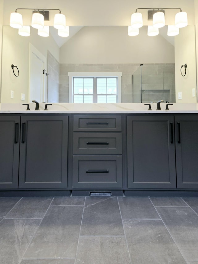 bathroom featuring vanity, walk in shower, and lofted ceiling