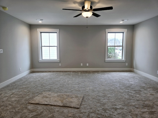 carpeted empty room featuring ceiling fan