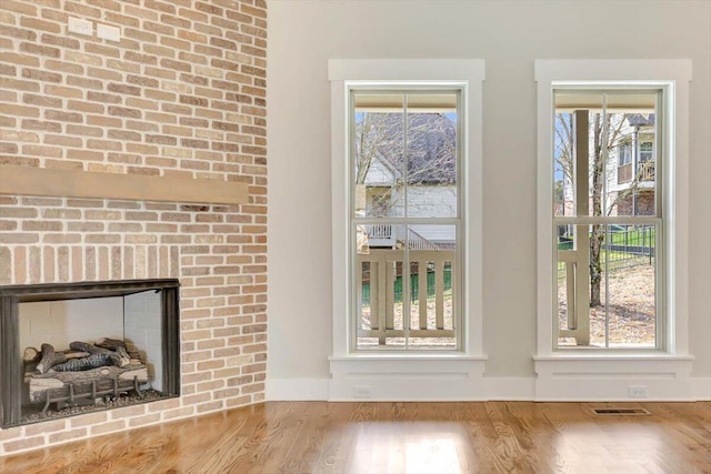 room details with a brick fireplace and wood-type flooring