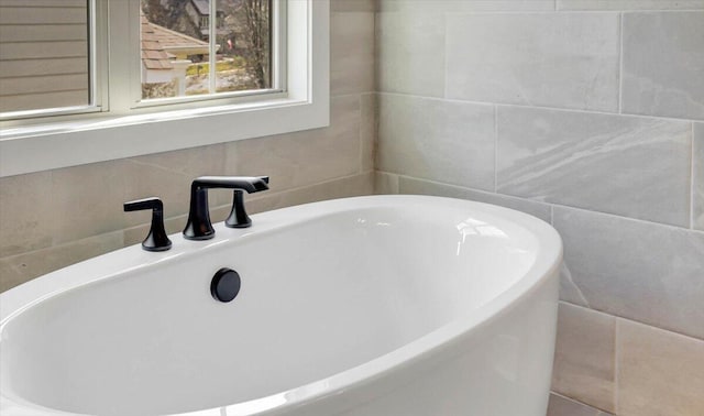 bathroom featuring sink, tile walls, and a tub