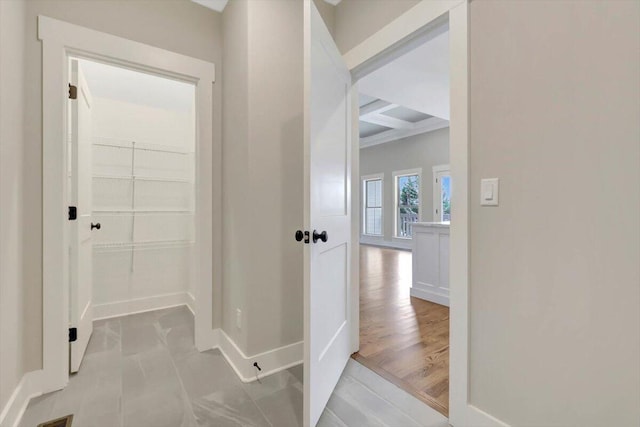 hallway featuring coffered ceiling and beam ceiling