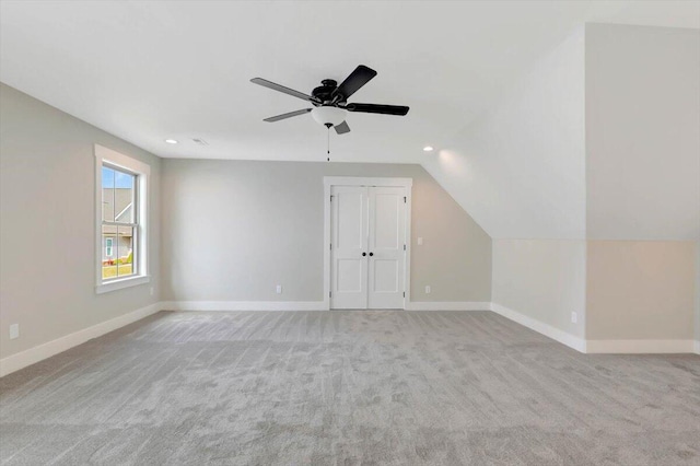 bonus room featuring lofted ceiling, light colored carpet, and ceiling fan