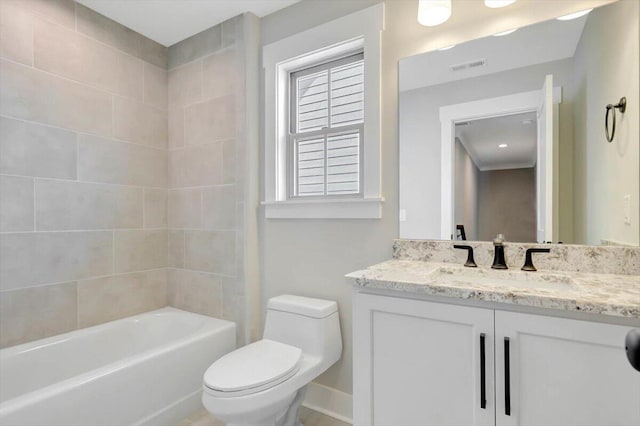 full bathroom with vanity, tiled shower / bath, and toilet