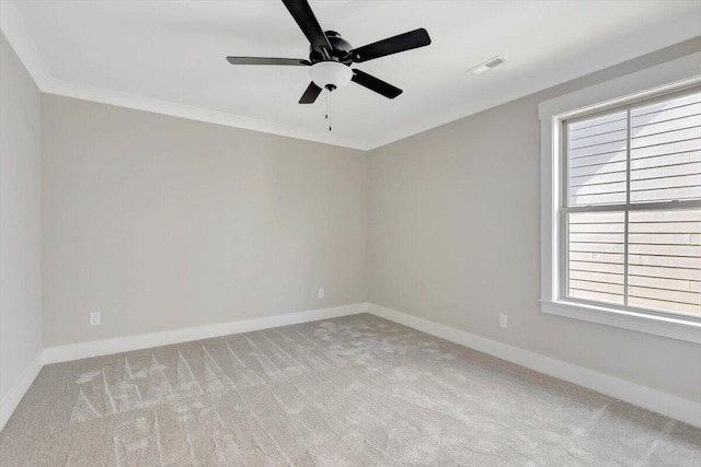 carpeted empty room with ornamental molding and ceiling fan