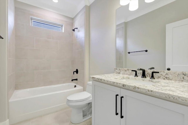 full bathroom featuring tiled shower / bath, vanity, toilet, and tile patterned floors