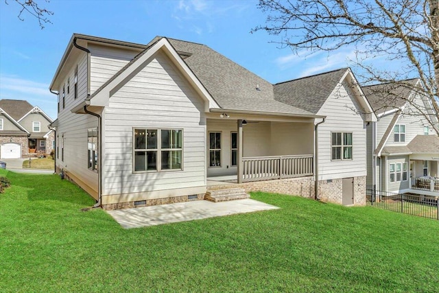 back of property with a patio, a yard, and covered porch