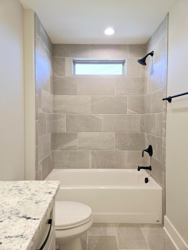 full bathroom featuring tile patterned floors, vanity, toilet, and tiled shower / bath combo