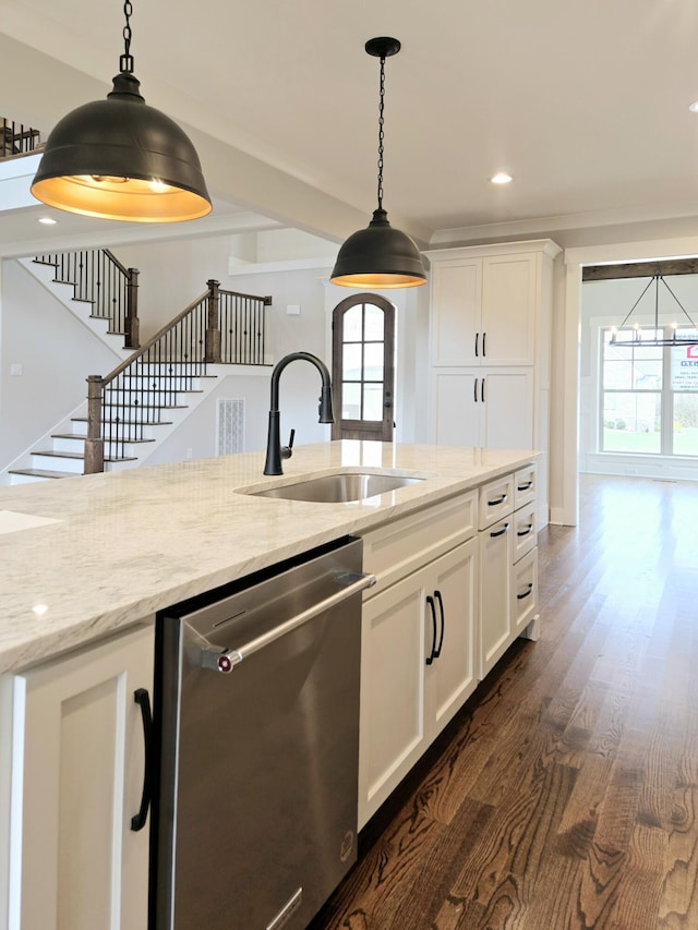 kitchen featuring sink, stainless steel dishwasher, white cabinets, and light stone countertops