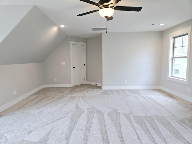 bonus room featuring vaulted ceiling, light colored carpet, and ceiling fan