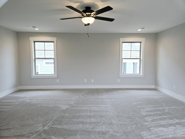 carpeted spare room with ceiling fan