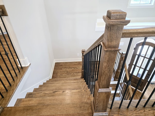 stairs featuring wood-type flooring