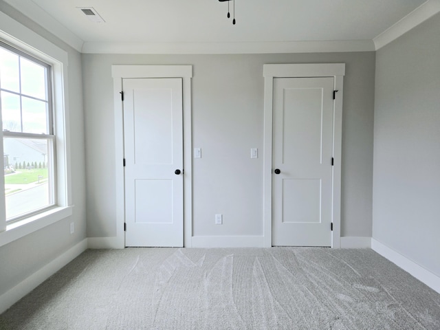 unfurnished bedroom with crown molding and carpet flooring