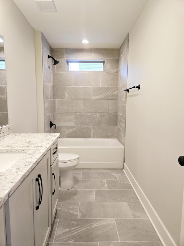 full bathroom with vanity, tiled shower / bath combo, and toilet