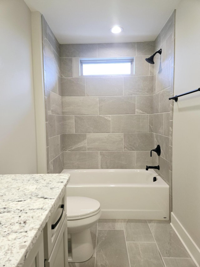 full bathroom with tiled shower / bath, vanity, and toilet