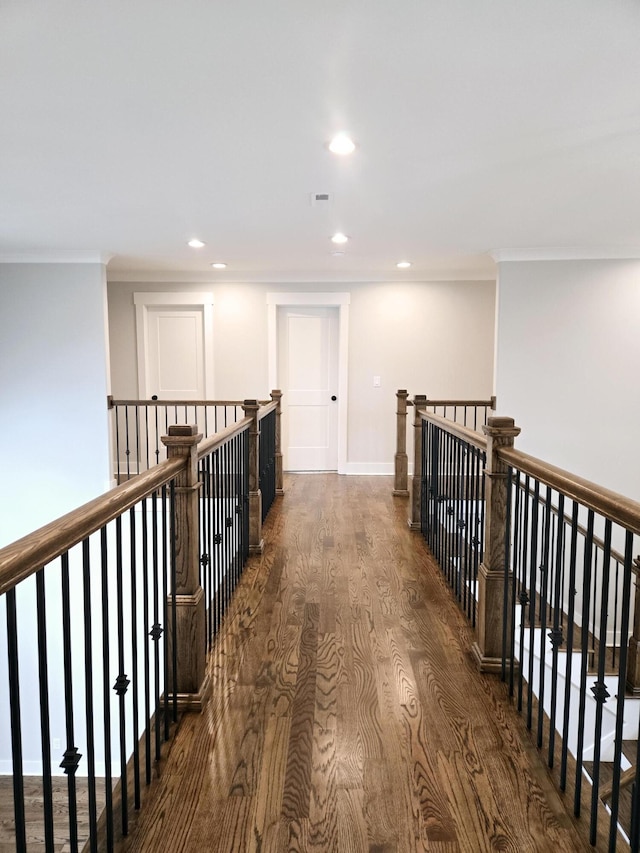 corridor with dark hardwood / wood-style flooring and crown molding