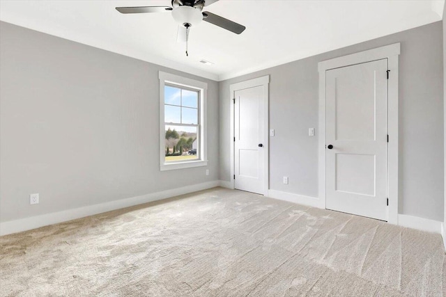 unfurnished bedroom with light colored carpet and ceiling fan