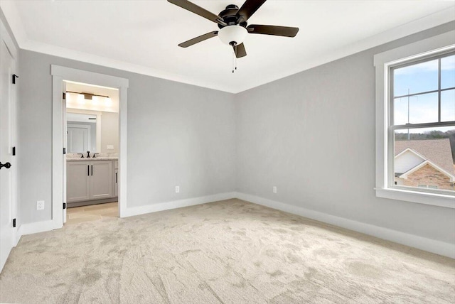 unfurnished bedroom featuring sink, ceiling fan, connected bathroom, ornamental molding, and light carpet