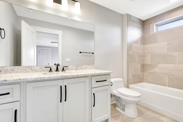 full bathroom featuring vanity, tile patterned flooring, tiled shower / bath combo, and toilet