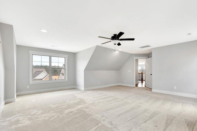 bonus room with light colored carpet and ceiling fan