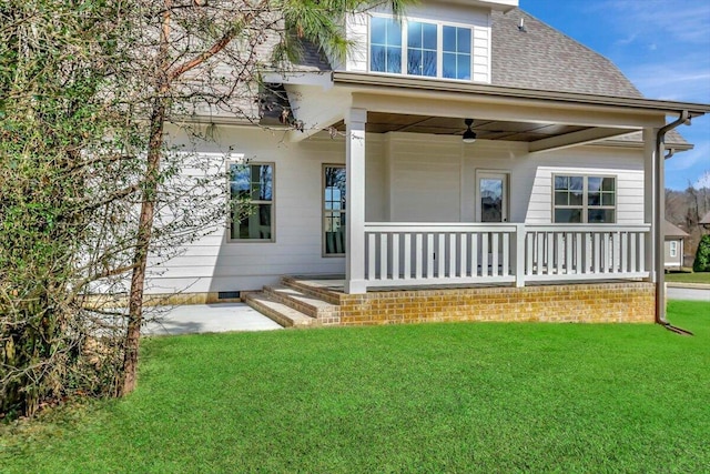 back of house featuring a yard, ceiling fan, and covered porch