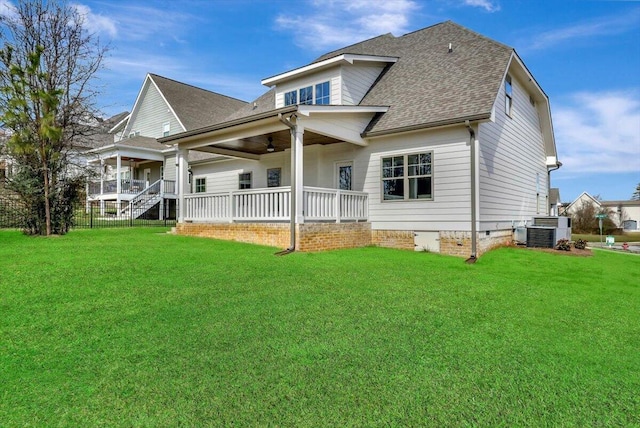 rear view of property featuring cooling unit, a yard, and a porch