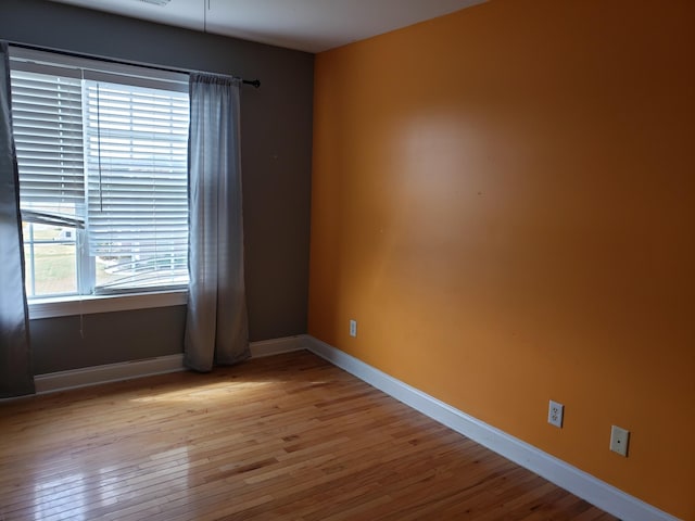 spare room with light hardwood / wood-style flooring