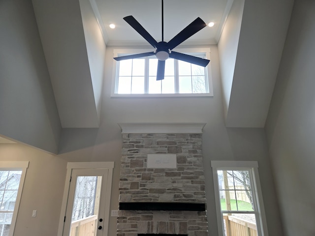 unfurnished living room featuring ceiling fan and a fireplace