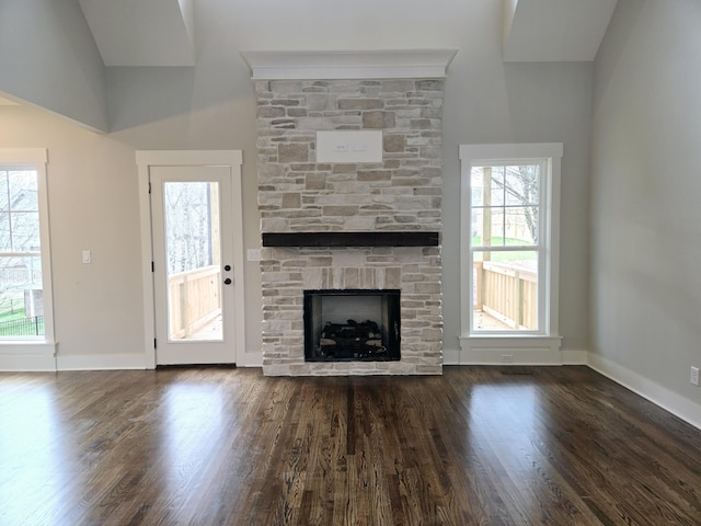 unfurnished living room with a fireplace and dark wood-type flooring