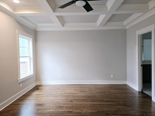 spare room featuring a wealth of natural light, dark wood-type flooring, and coffered ceiling