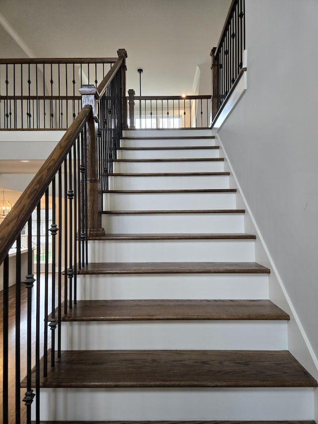 stairs with a chandelier