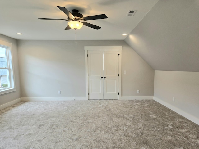 additional living space featuring carpet flooring, ceiling fan, and lofted ceiling