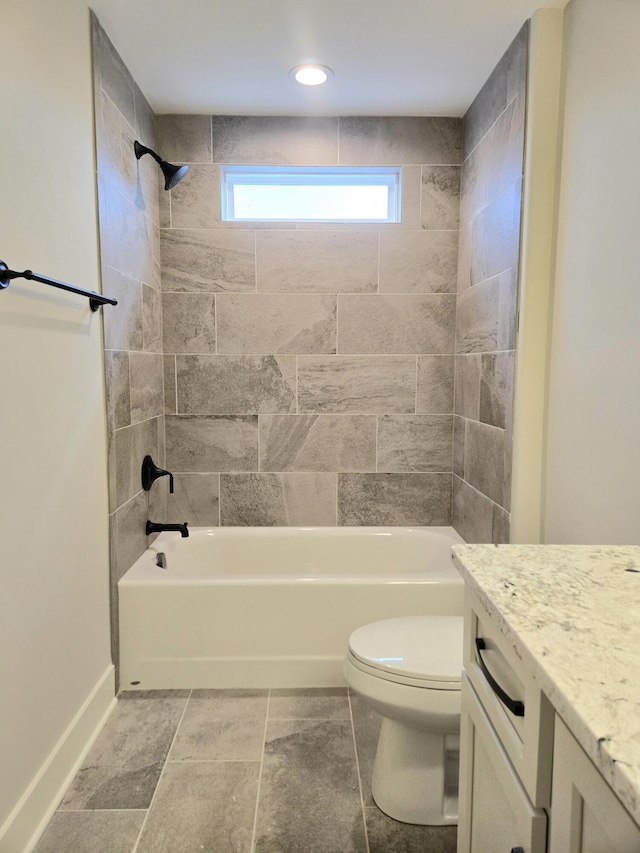 full bathroom with tiled shower / bath, vanity, and toilet