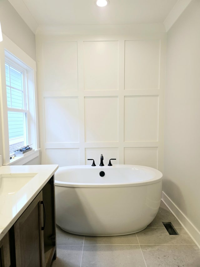 bathroom with crown molding, a washtub, vanity, and tile patterned flooring