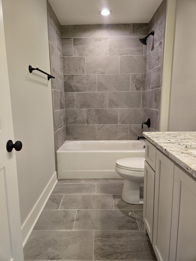 full bathroom with vanity, toilet, and tiled shower / bath combo