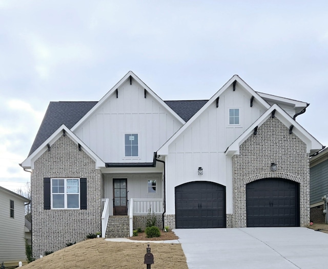 view of front facade with covered porch and a garage