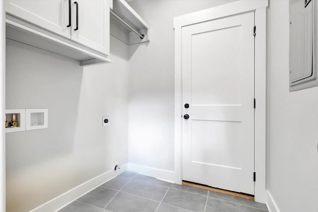 clothes washing area with hookup for a washing machine, cabinet space, hookup for an electric dryer, dark tile patterned floors, and baseboards