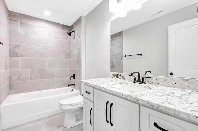 bathroom with shower / washtub combination, visible vents, vanity, and toilet