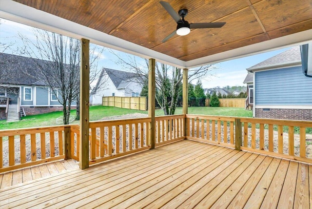 wooden deck with a yard, ceiling fan, and fence