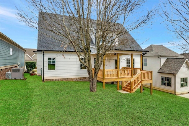 back of property with a yard, a shingled roof, stairway, central AC unit, and a deck