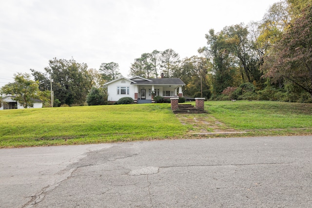 view of front of property with covered porch and a front lawn