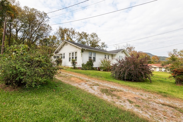 view of property exterior with a yard