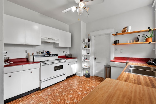 kitchen with sink, butcher block countertops, white range with electric cooktop, ceiling fan, and white cabinets