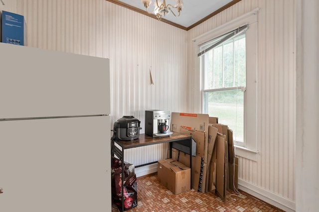 kitchen featuring ornamental molding, a chandelier, and white refrigerator