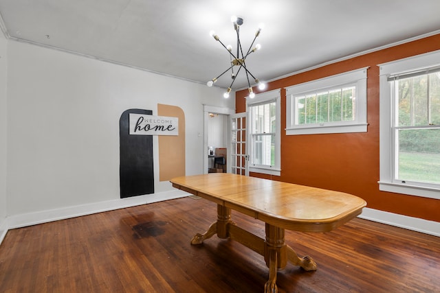 unfurnished dining area with an inviting chandelier and hardwood / wood-style floors