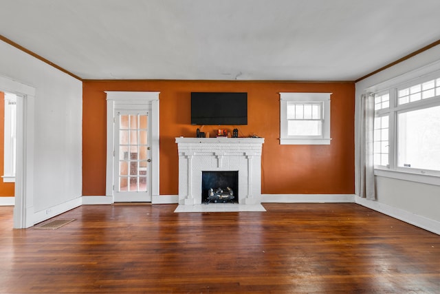 unfurnished living room with crown molding and dark hardwood / wood-style floors