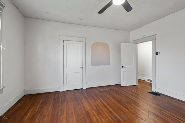 spare room featuring ceiling fan and dark hardwood / wood-style floors