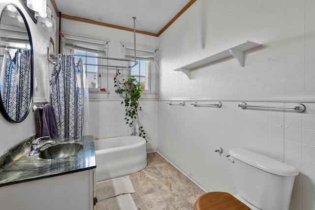 bathroom with vanity, toilet, tile walls, and a washtub