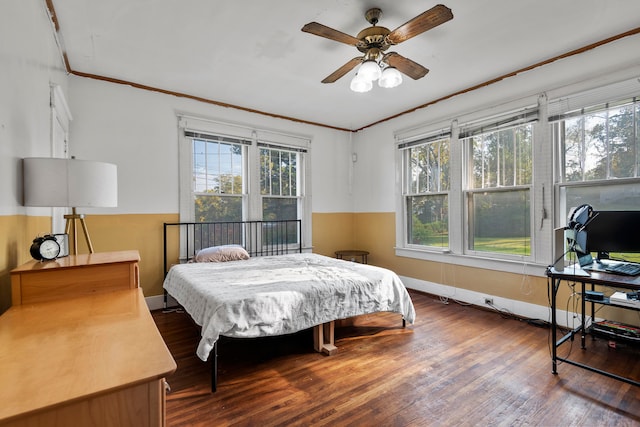 bedroom featuring crown molding, ceiling fan, multiple windows, and dark hardwood / wood-style flooring