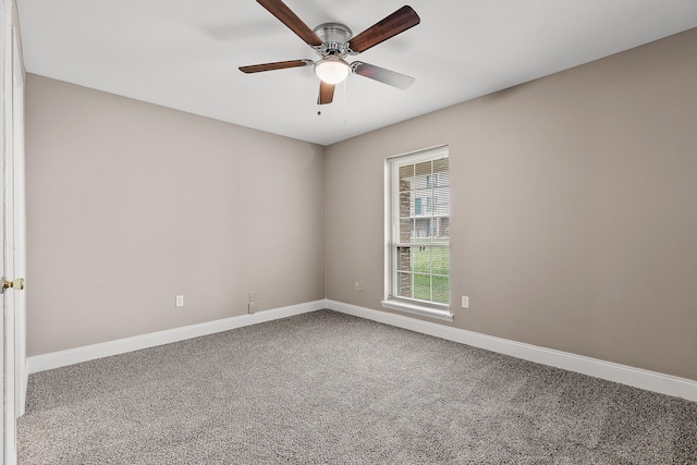 spare room with ceiling fan and carpet